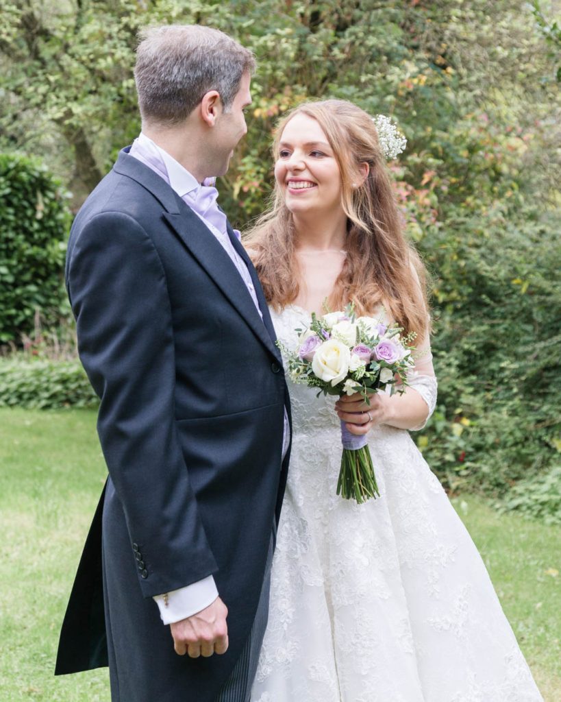 Church of the Immacualte Conception, Portswood, Southampton – bride holding bouquet looking lovingly at groom