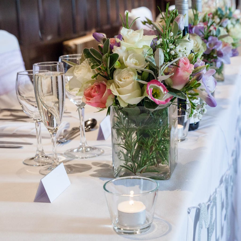 Bartley Lodge New Forest Hotel, Hampshire – flowers adorn the top table at a wedding reception at the