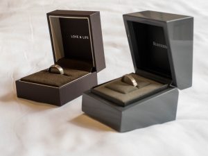 Love and Life bridegroom wedding ring in box next to bridal ring in separate box
