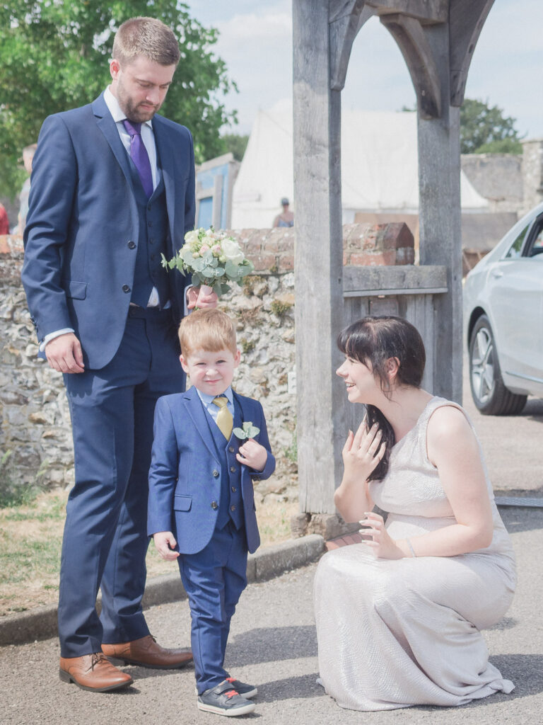 Father, mother and young son at summer wedding
