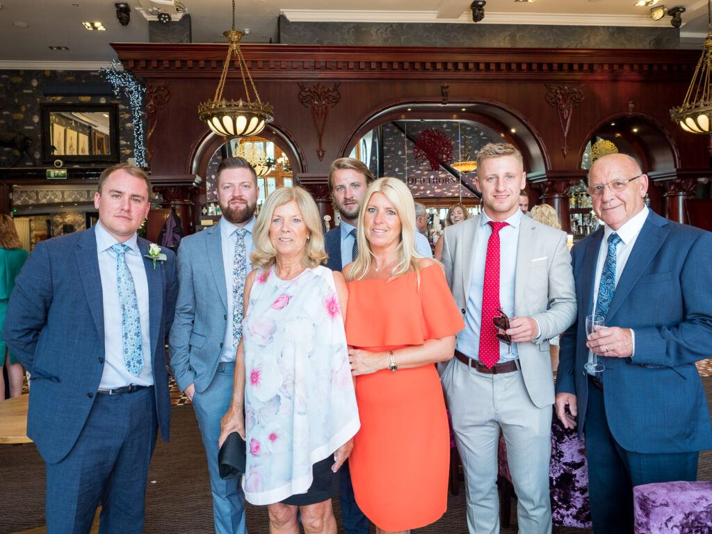 Wedding guests pose during cocktail hour