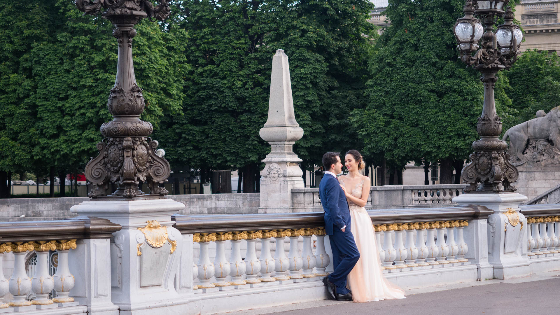 Elegant couple in wedding dress on the Pont Aleandre III with the Grand Palais in the background