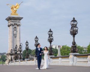 Oriental couple in wedding dress on the Pont Aleandre III