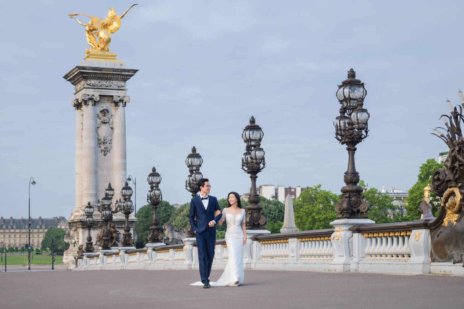 Oriental couple in wedding dress on the Pont Aleandre III