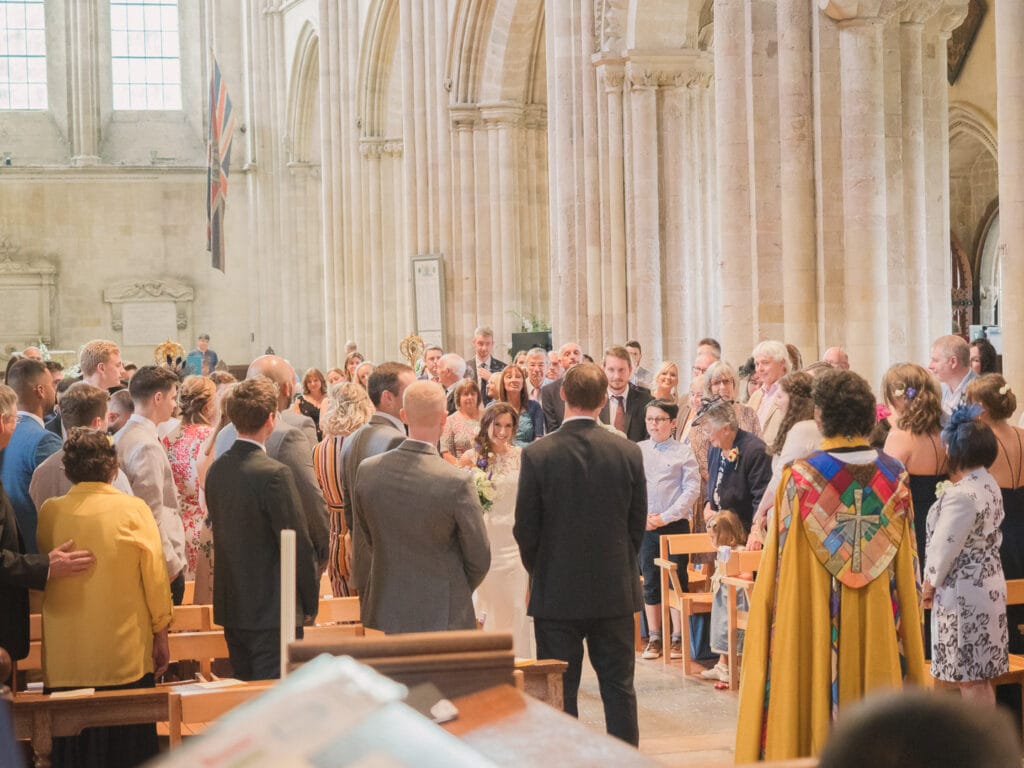 A bride greets her bridegroom at their wedding in Romsey Abbey
