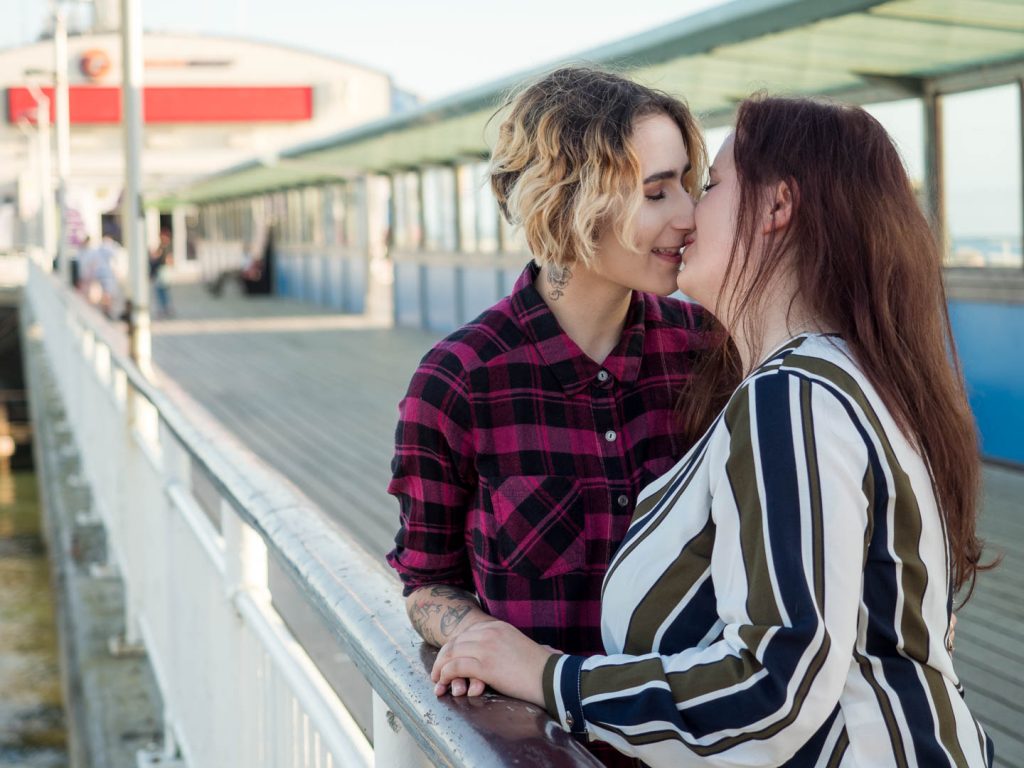 Lesbian couple kissing on Bournemouth Pier