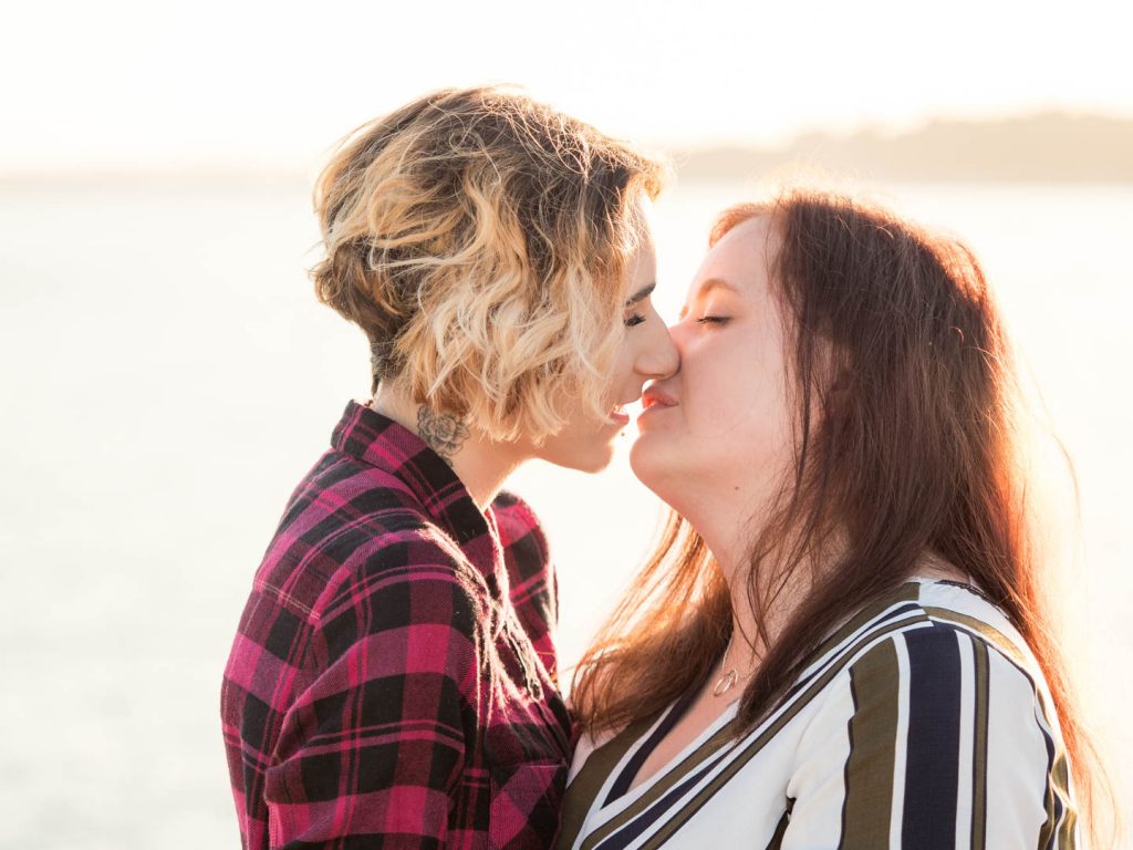 Lesbian couple about to kiss on Bournemouth Pier