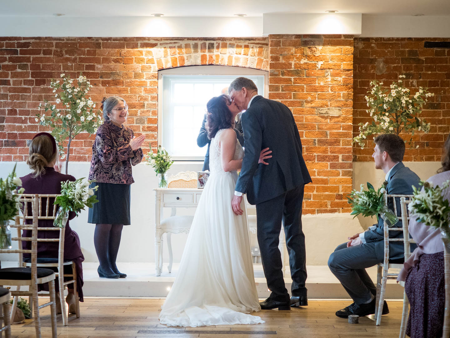 Bride and groom kiss during their wedding ceremony at Sopley Mill