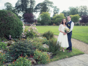 Bride and groom look into the distance in the grounds of The Orangery Suite
