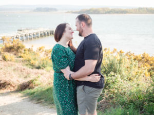 Couple on engagement photo session, enjoying romantic moment above Lake Beach, Poole Harbour, Dorset
