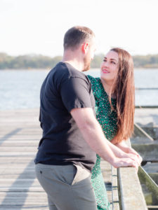 Couple on engagement photo session, standing on Lake Pier, Poole Harbour, Dorset