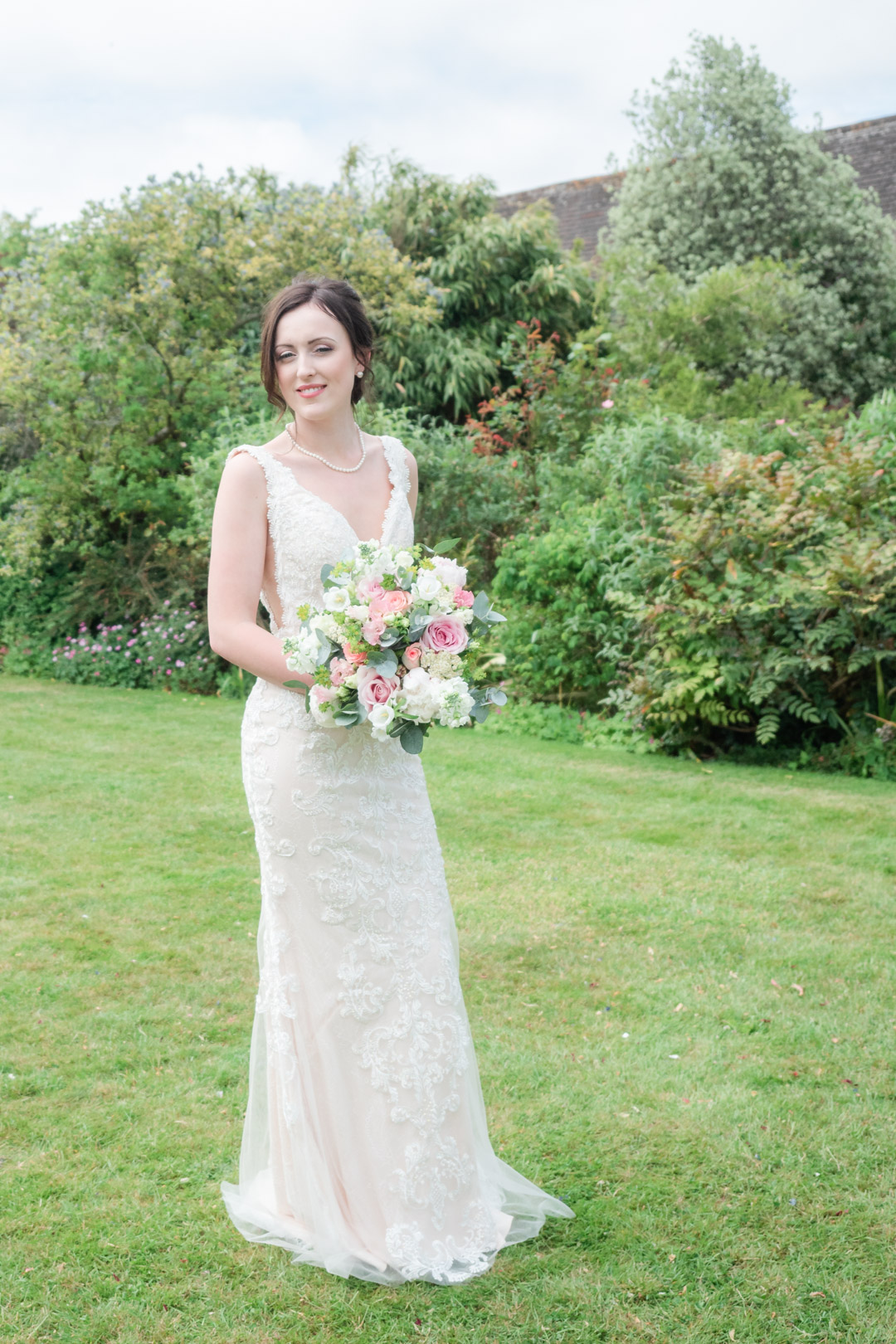 Bride holding bouquet on a lawn