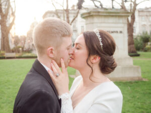 Bride and groom kiss in St. James's Square, London