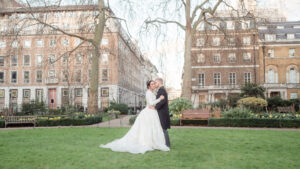 Groom kisses bride in St. James's Square, London