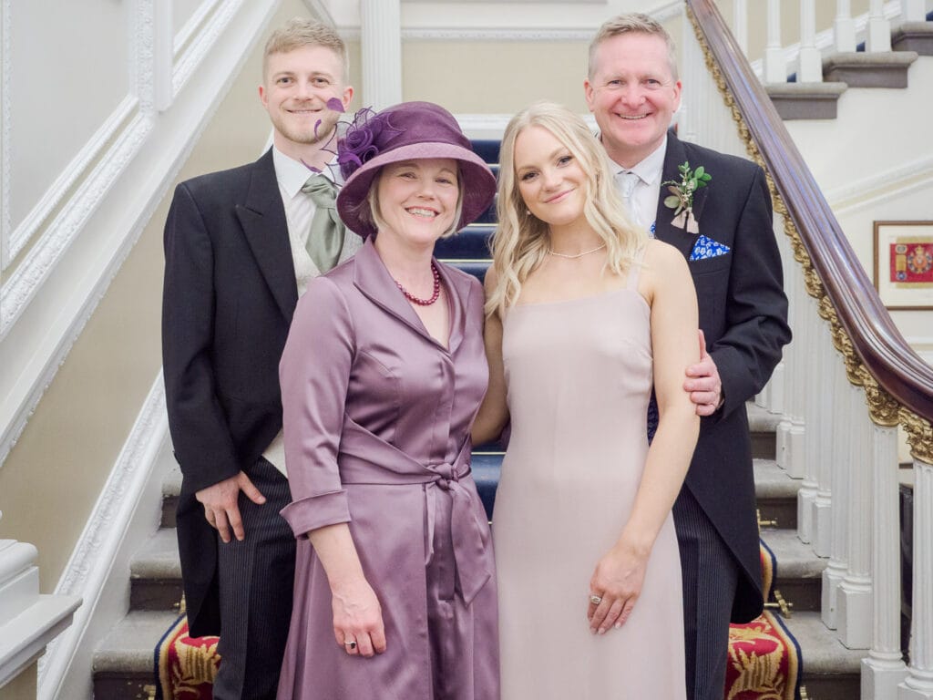 Bridegroom and family on the stairs at the Naval and Military Club