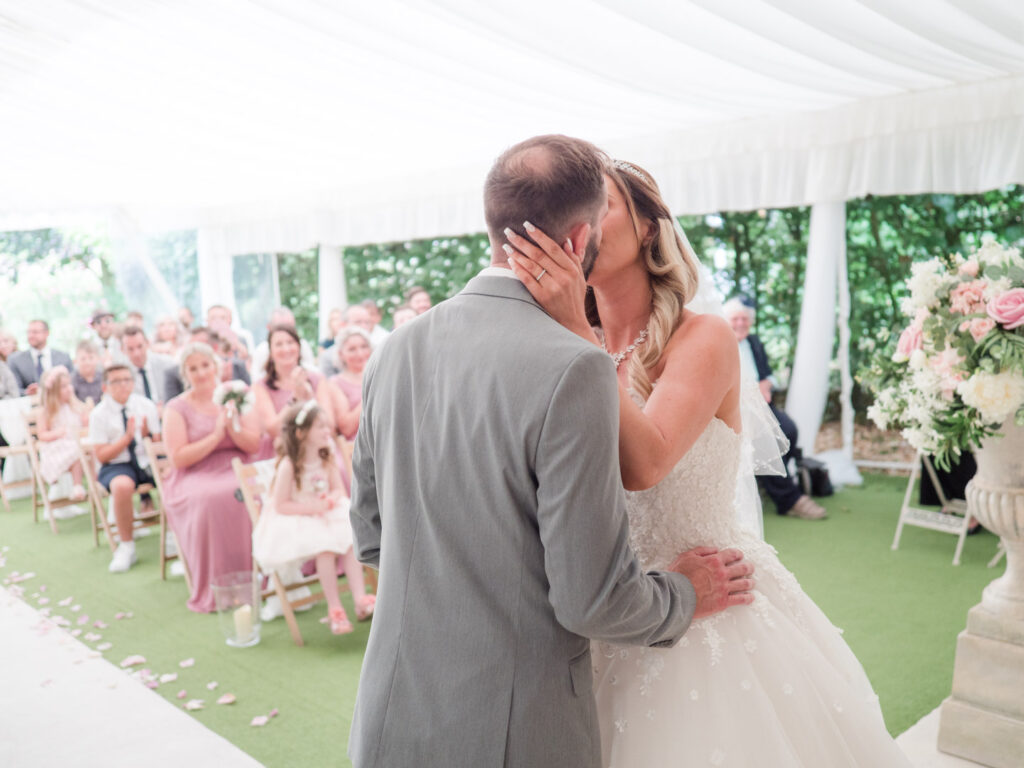 Bride and groom enjoy their first kiss