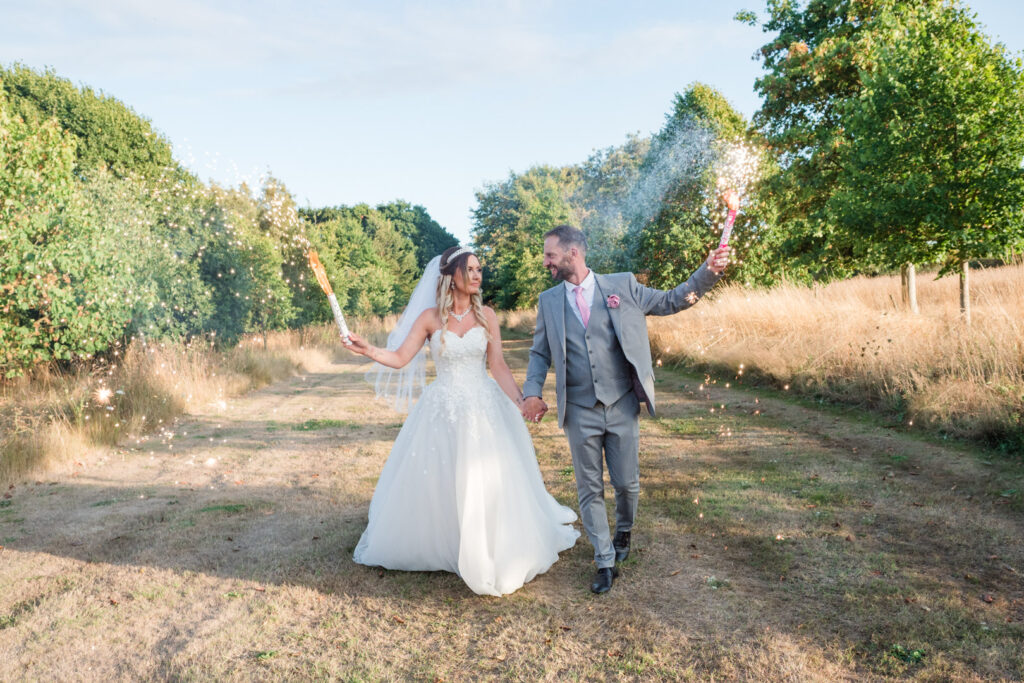 Bride and groom carry firework torches