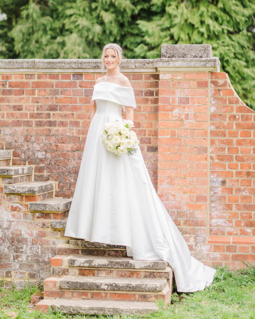 Bride on stone steps in garden