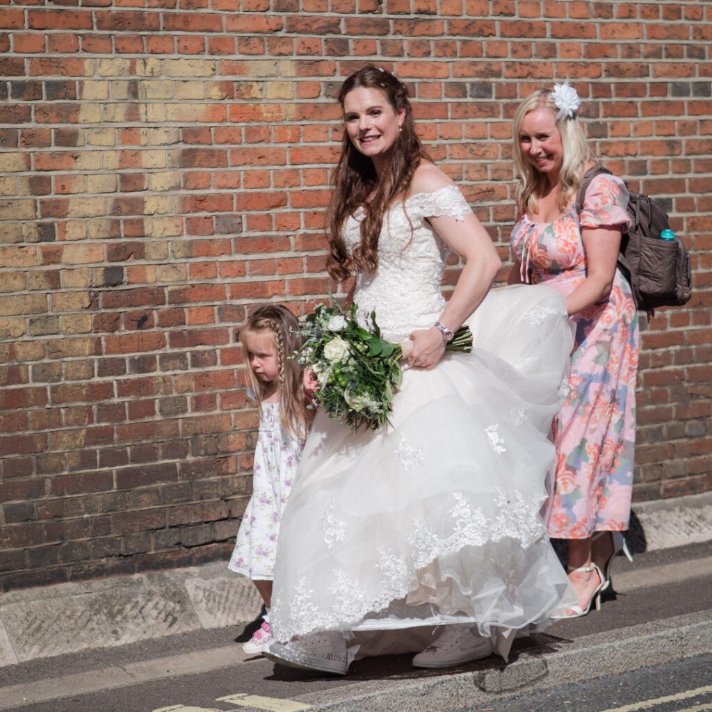 Smiling bride photographed on sunny street