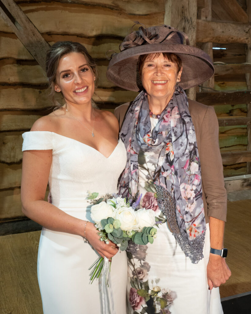 Bride and mother at wedding reception in Titchfield Great Barn