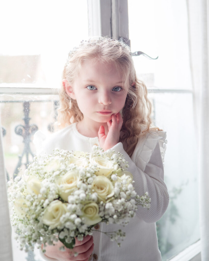 Young bridesmaid in front of a window