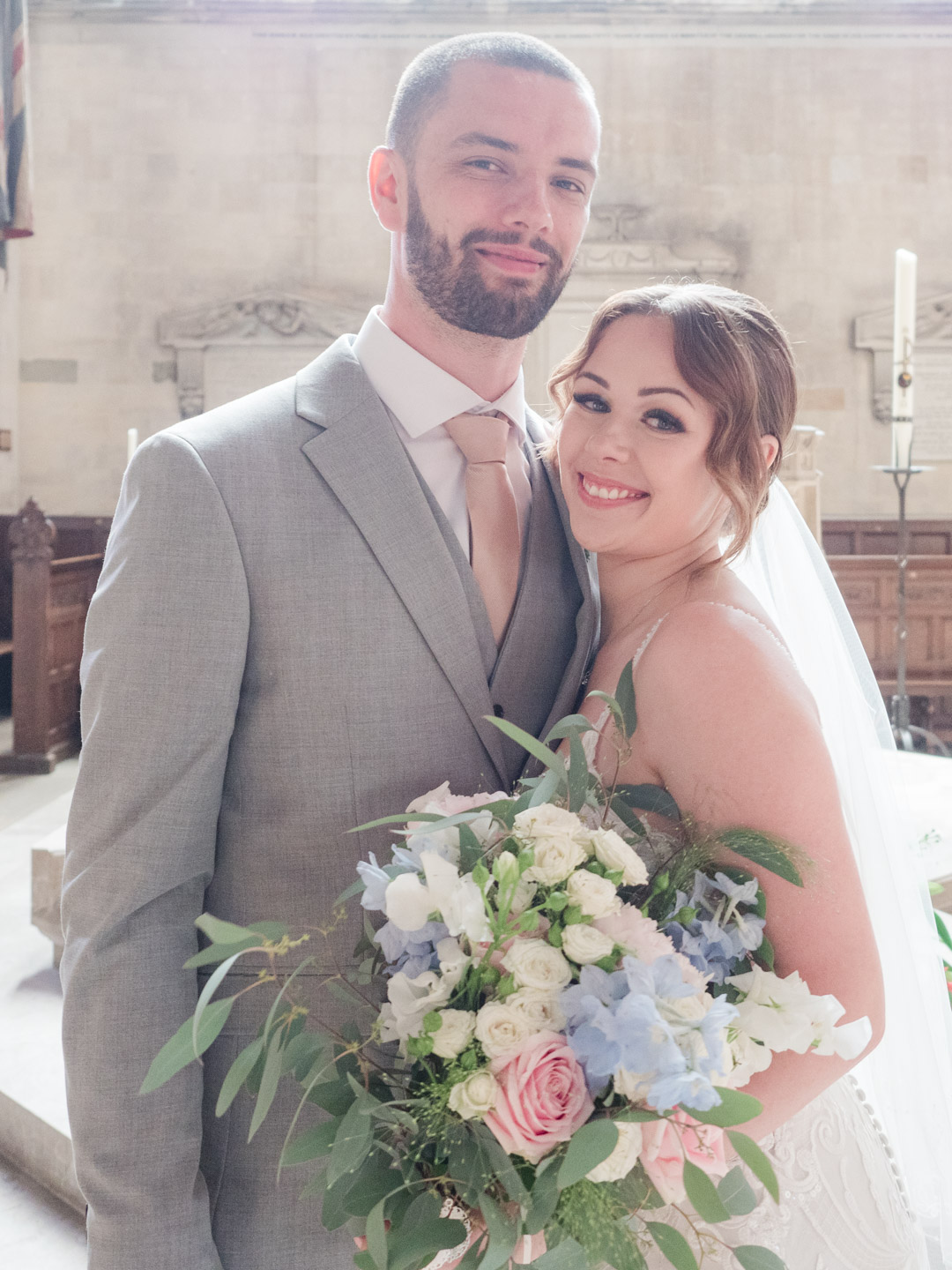 Portrait of bride and groom in Romsey Abbey