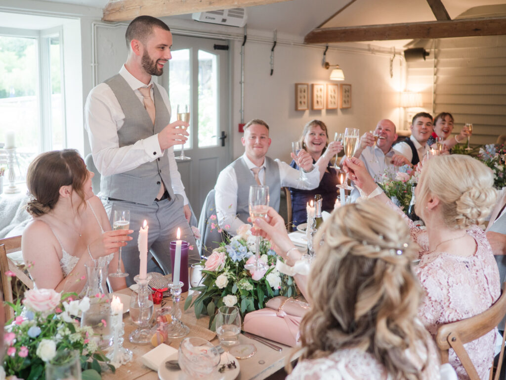 Groom toasts his marriage with guests at Kimbridge Barn