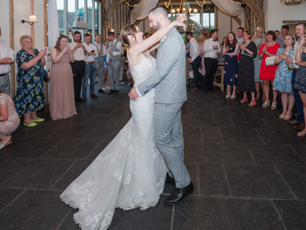 Bride and groom kiss on the dance floor  at Kimbridge Barn