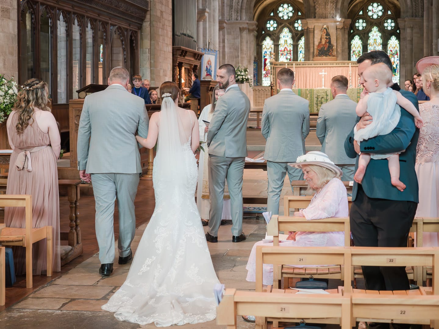 Groom greets his bride in Romsey Abbey