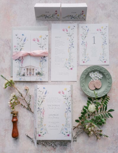 Flat lay of stationery and pretty details for a wedding at Rookesbury Park.