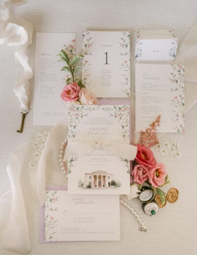 Flat lay of stationery and pretty details for a wedding at Rookesbury Park.