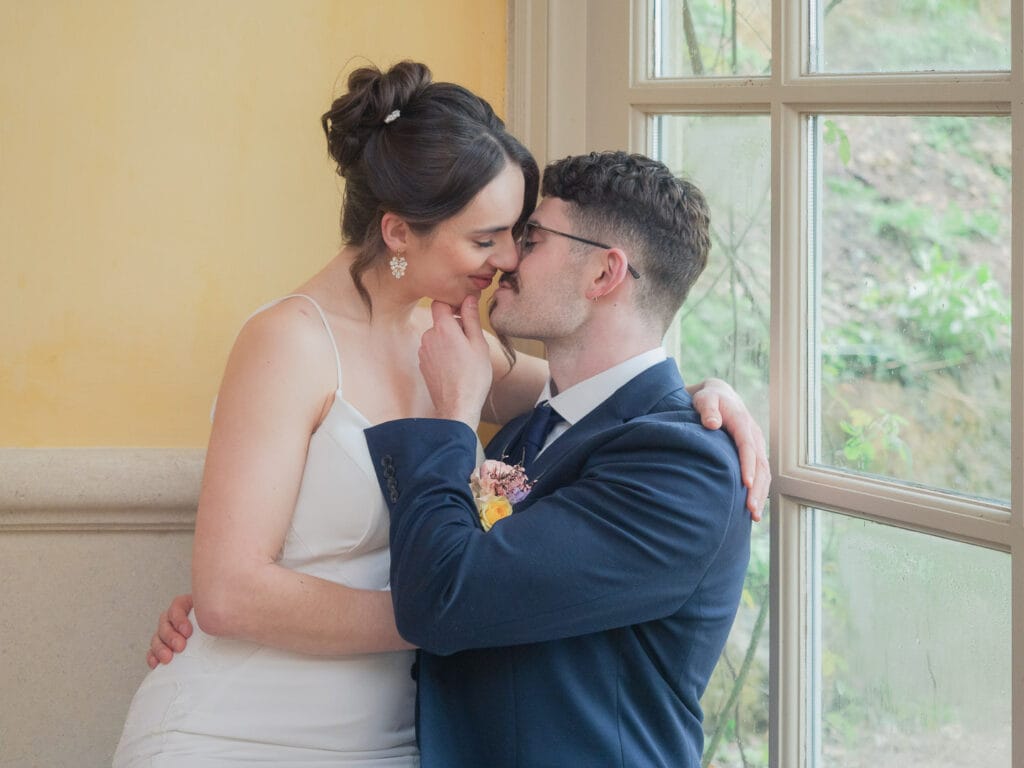 Notre-Dame de Paris Bridal couple make out in corner of great hall in Euridge Manor