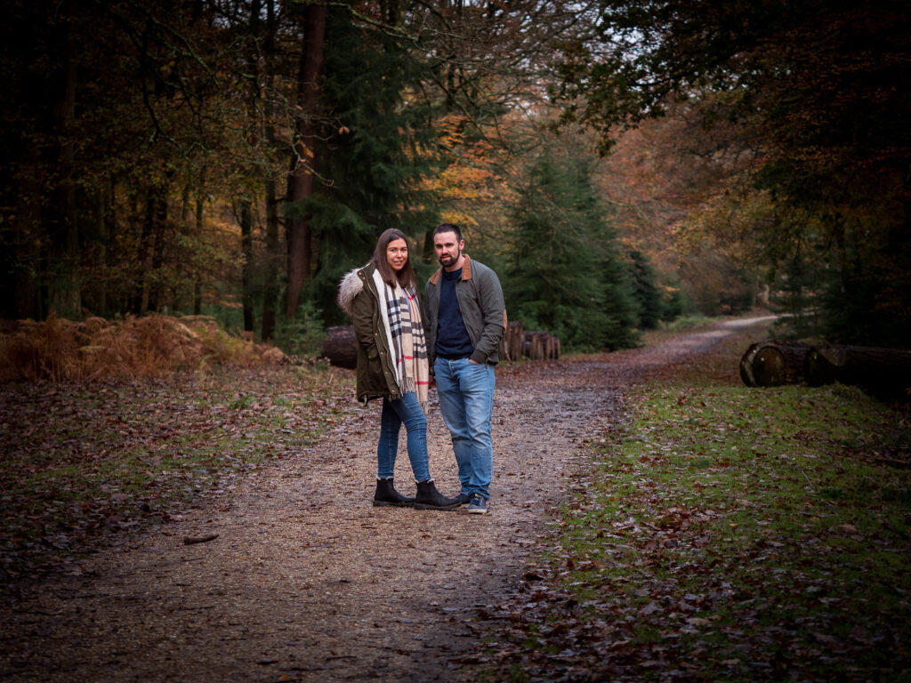 Couple on woodland path in autumn