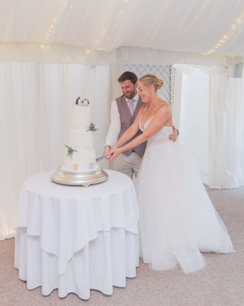 Bride and groom cut their cake at Parley Manor