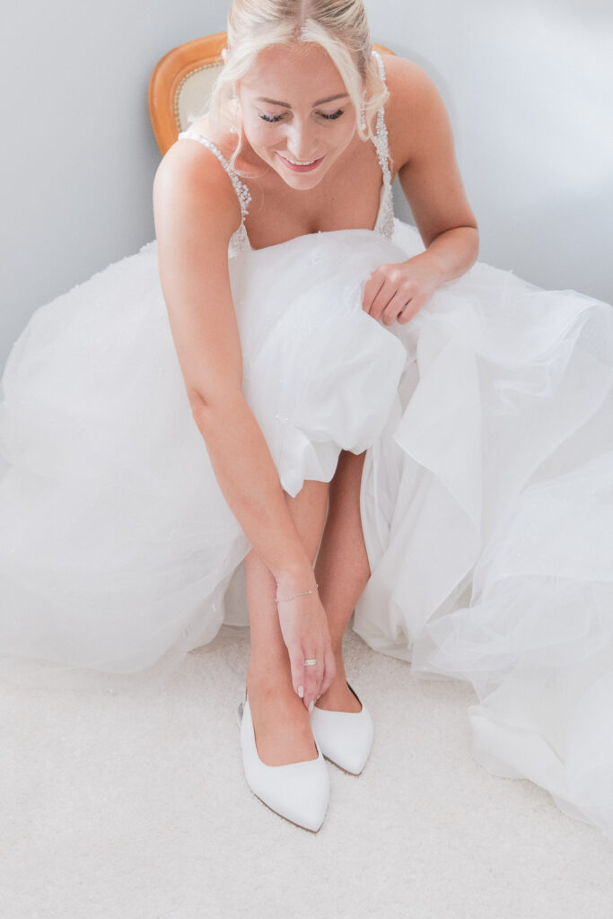 Bride puts on her wedding shoes