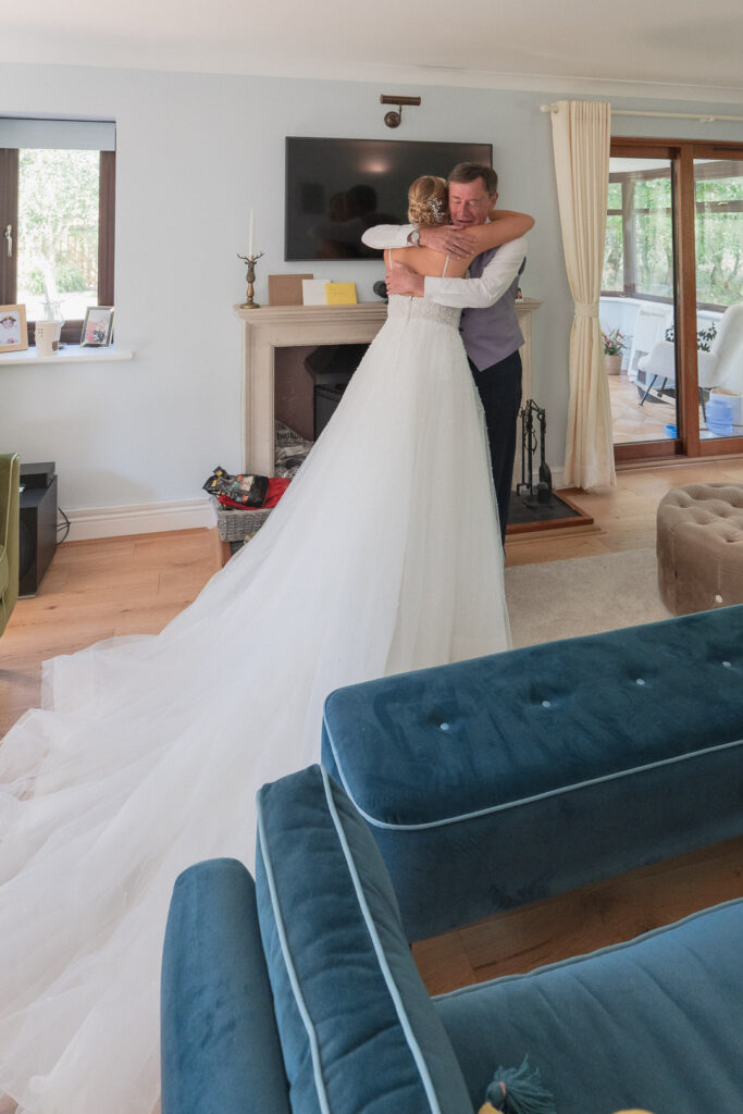 Father hugs his daughter on the morning of her wedding day