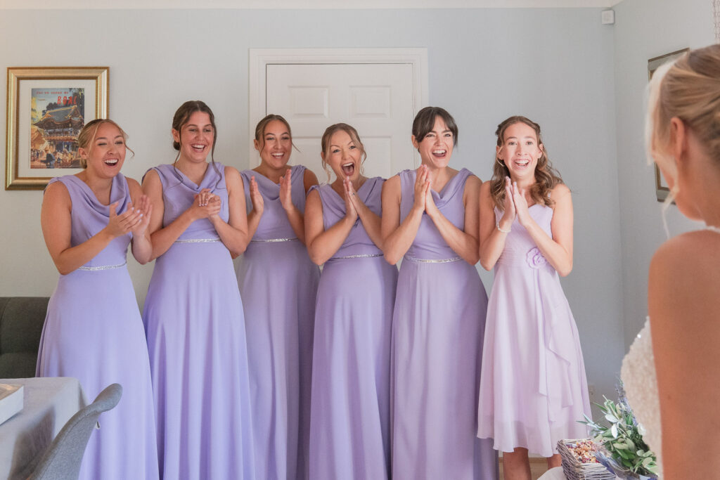 First look at bride for delighted bridesmaids