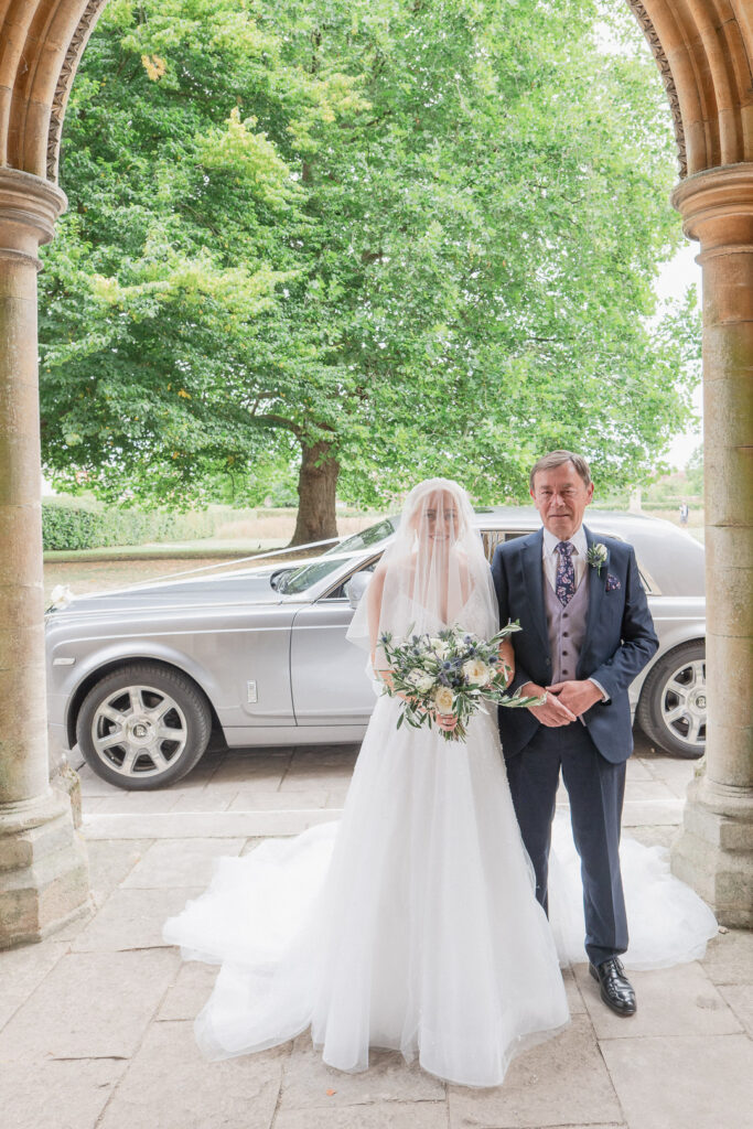 Bride and her father outside Romsey Abbey