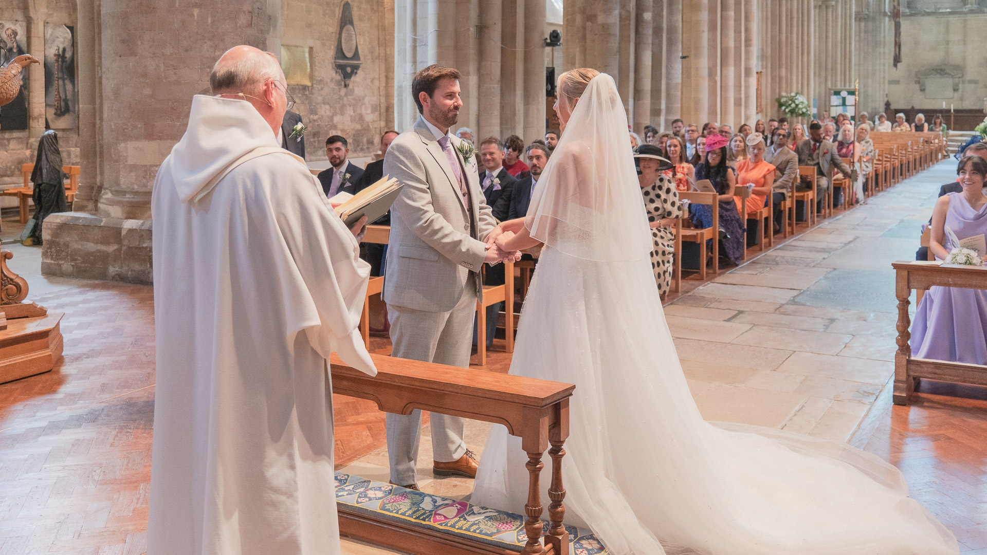 Bride and groom exchange wedding vows in Romsey Abbey