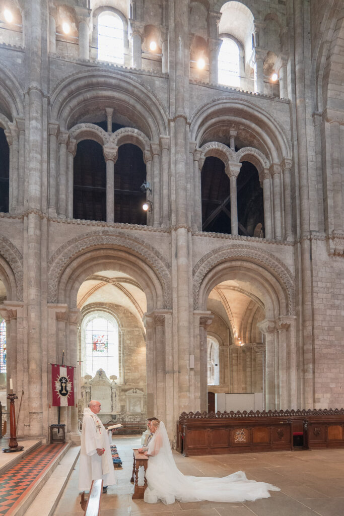 Bride and groom at the high altar in Romsey Abbey